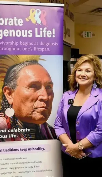 Woman standing by large banner